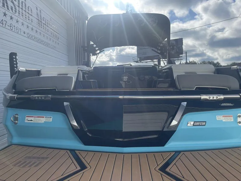 Slide: The Image of 2022 MasterCraft X26 boat with blue and black exterior, docked at Dockside Marine. - 4