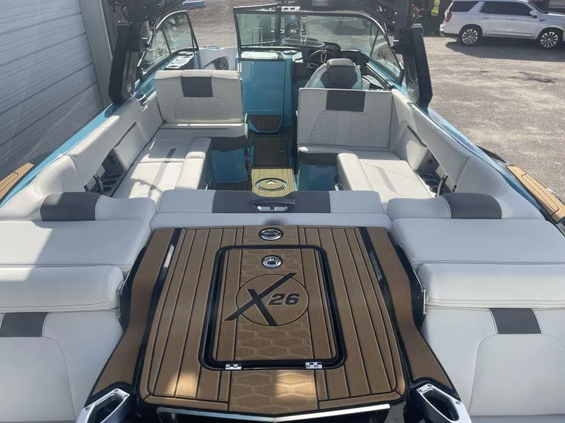 Slide: The Image of 2022 MasterCraft X26 boat interior with luxurious seating and teak flooring. - 5