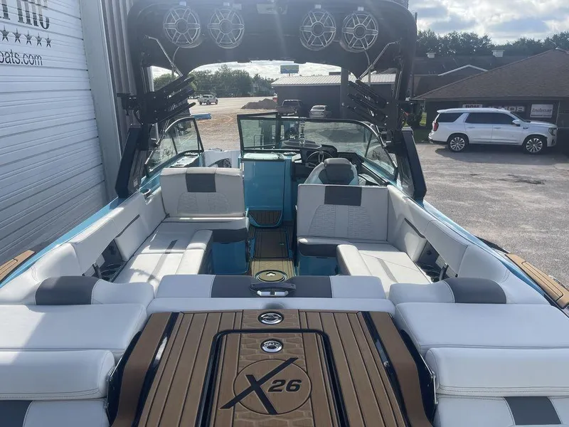 Slide: The Image of 2022 MasterCraft X26 boat interior with luxurious seating and advanced audio system. - 6