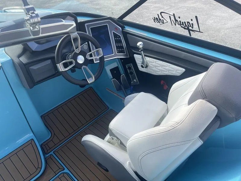 Slide: The Image of 2022 MasterCraft X26 boat cockpit with modern steering wheel and touchscreen controls. - 7