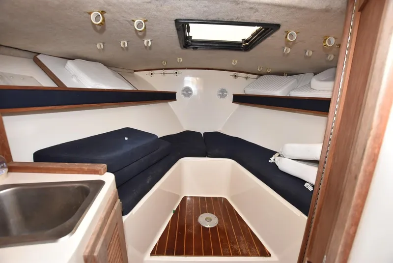 Slide: The Image of 2001 Carolina Classic Express with Marlin Tower cabin interior, featuring a cozy sleeping area and sink. - 12