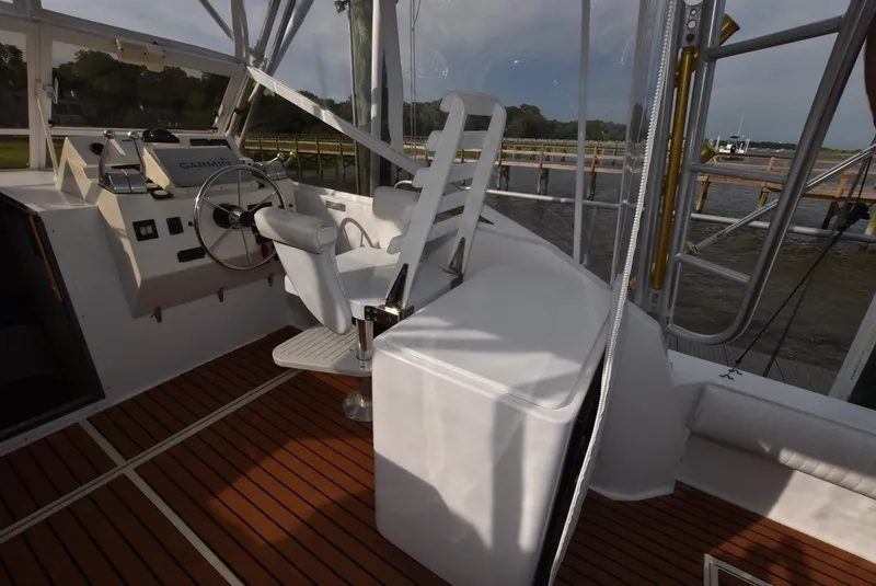 Slide: The Image of 2001 Carolina Classic Express with Marlin Tower, helm station with wooden deck and white seating. - 6