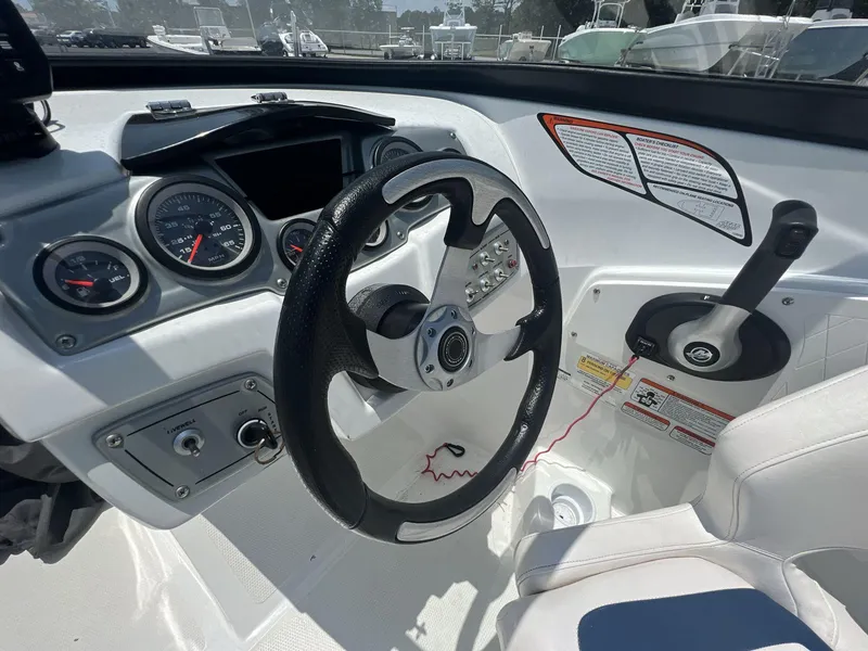 Slide: The Image of 2017 Tahoe 500 TF boat dashboard with steering wheel and control panel. - 7