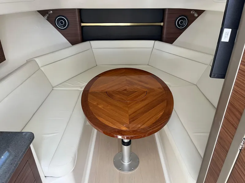 Slide: The Image of Luxurious interior of 2025 Boston Whaler 325 Conquest with elegant wood table and white seating. - 13