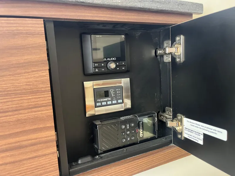 Slide: The Image of Control panel inside a 2025 Boston Whaler 325 Conquest boat cabinet. - 14