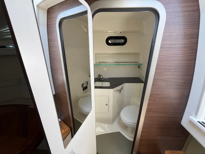 Slide: The Image of Interior of 2025 Boston Whaler 325 Conquest boat bathroom with modern amenities. - 17