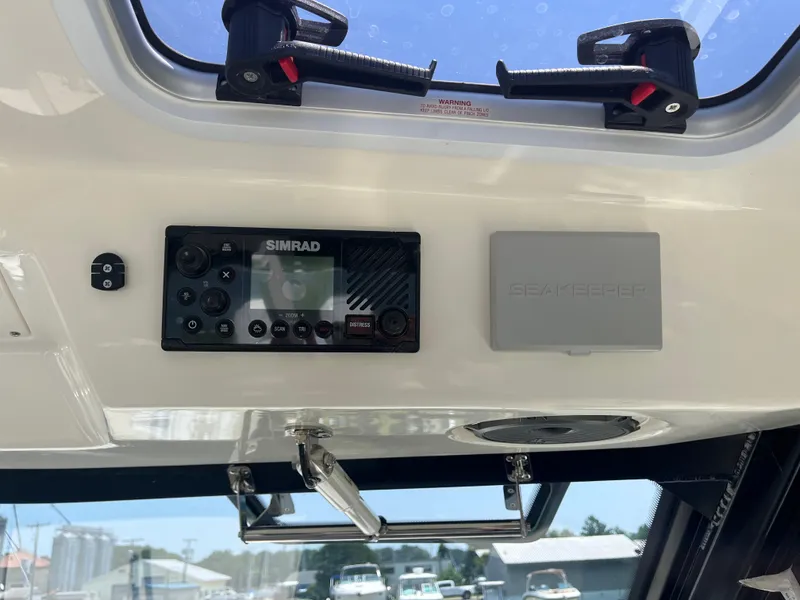 Slide: The Image of Control panel of 2025 Boston Whaler 325 Conquest with Simrad and Seakeeper systems. - 25