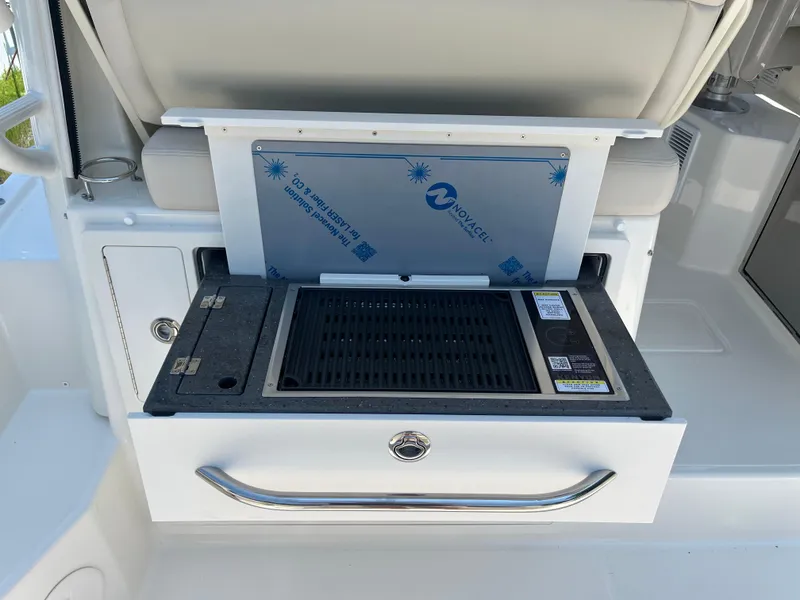 Slide: The Image of 2025 Boston Whaler 325 Conquest boat grill station with storage drawer. - 29