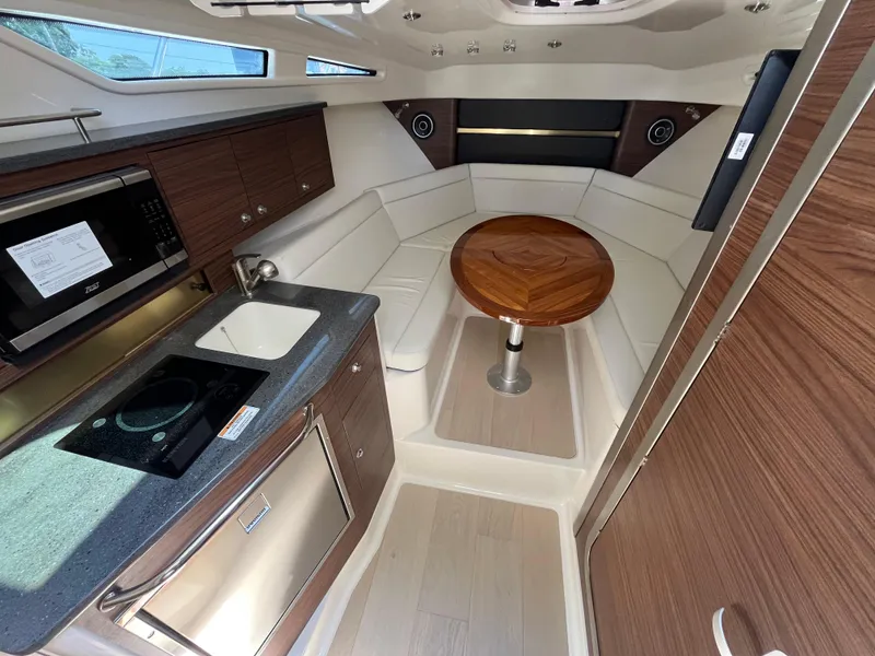 Slide: The Image of Luxurious interior of 2025 Boston Whaler 325 Conquest with kitchenette and seating area. - 3