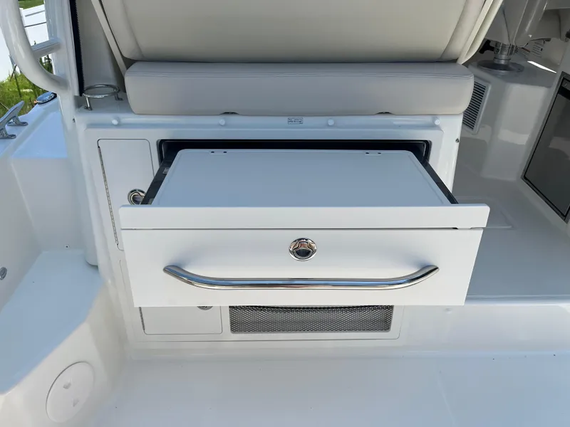 Slide: The Image of 2025 Boston Whaler 325 Conquest boat interior with open storage compartment. - 30