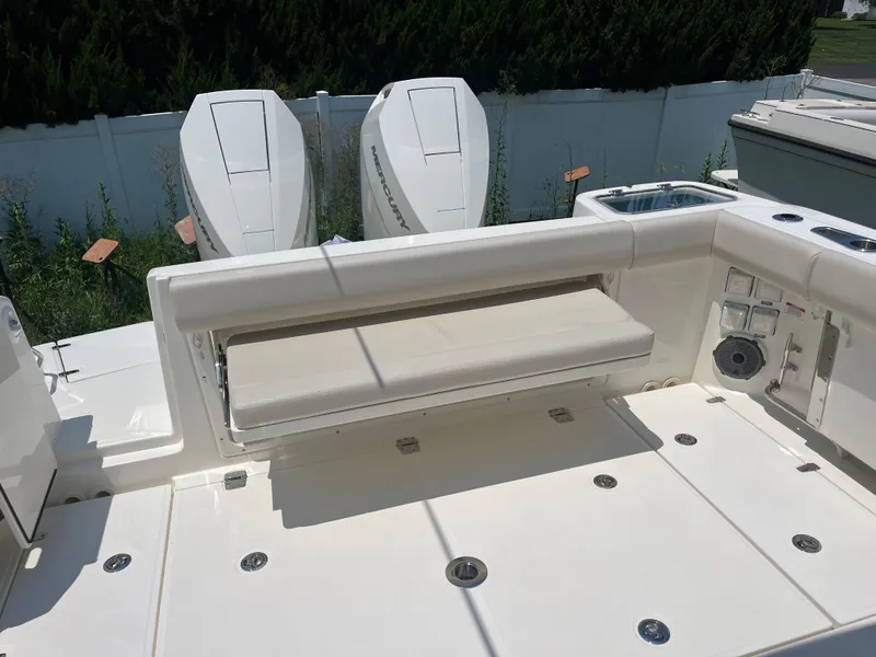 Slide: The Image of 2025 Boston Whaler 325 Conquest boat interior with seating and dual Mercury engines. - 33