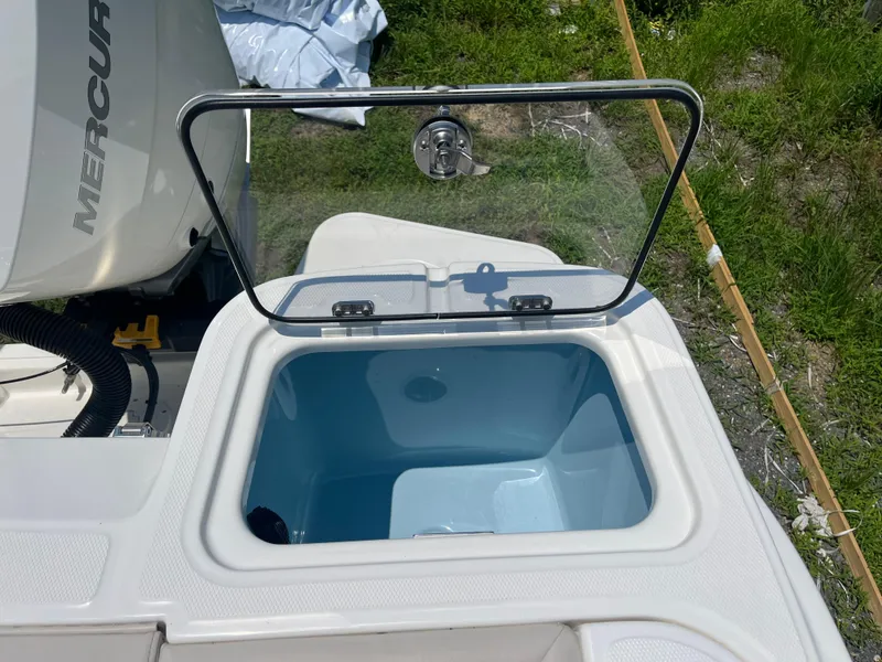 Slide: The Image of Open hatch on 2025 Boston Whaler 325 Conquest boat, revealing storage compartment. - 34