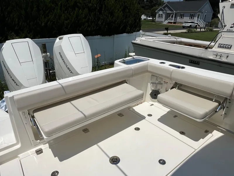 Slide: The Image of 2025 Boston Whaler 325 Conquest boat interior with seating and Mercury engines. - 35