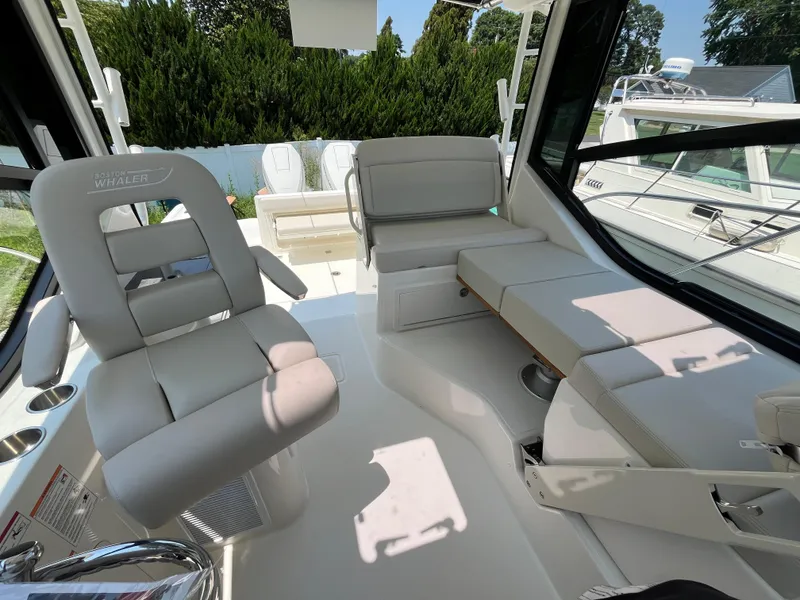 Slide: The Image of 2025 Boston Whaler 325 Conquest interior with plush seating and modern design. - 4