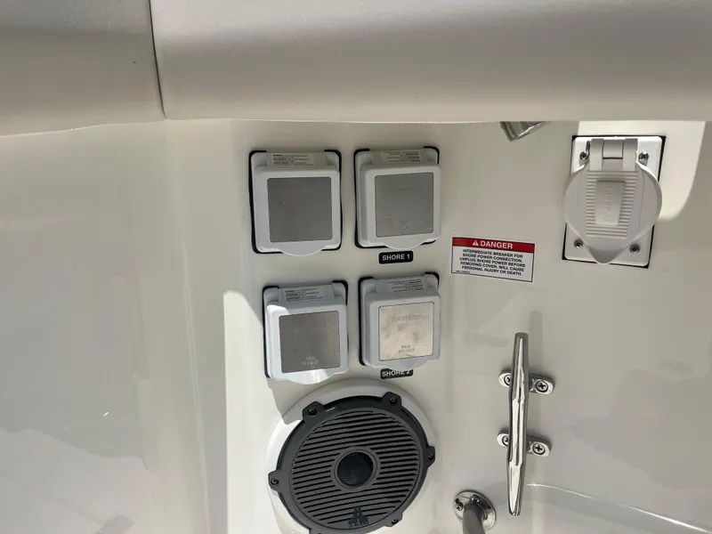 Slide: The Image of Electrical panel on 2025 Boston Whaler 325 Conquest boat, featuring shore power connections. - 40
