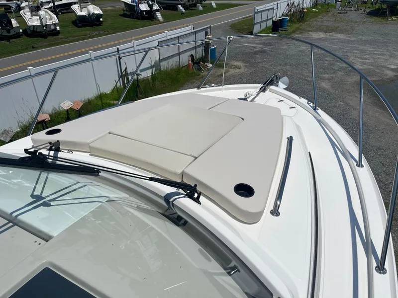 Slide: The Image of 2025 Boston Whaler 325 Conquest boat deck with cushioned seating and railing. - 45