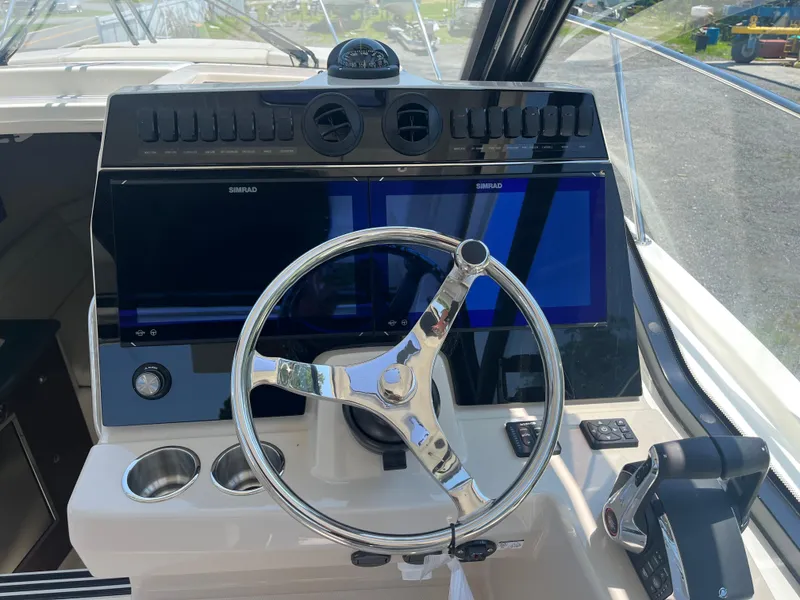 Slide: The Image of Steering console of 2025 Boston Whaler 325 Conquest with dual Simrad displays. - 5