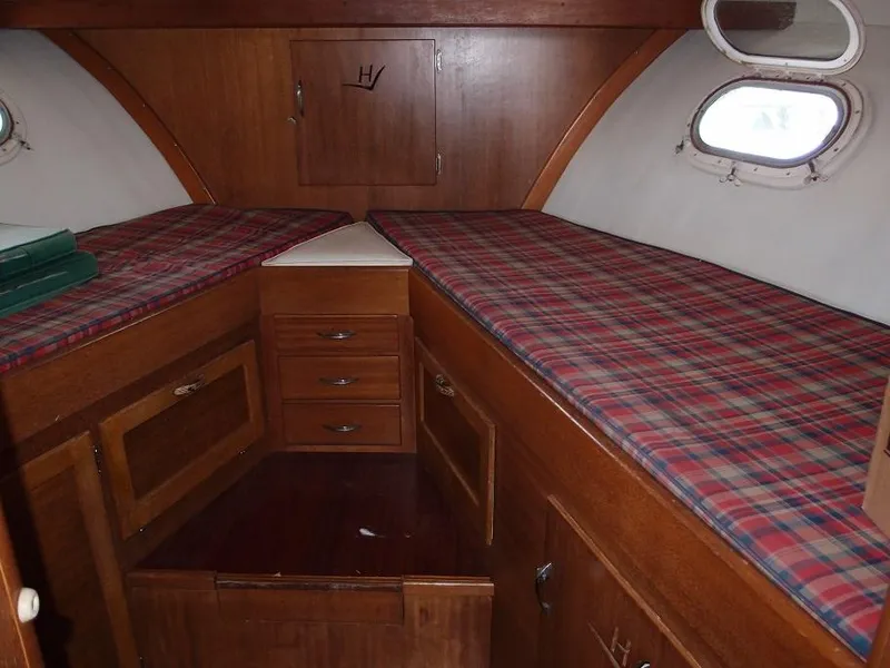 Slide: The Image of Interior cabin of a 1961 Hatteras Convertible boat with twin beds and wooden cabinetry. - 20