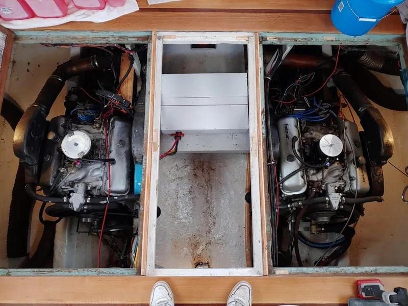 Slide: The Image of 1961 Hatteras Convertible engine compartment with twin engines and wiring. - 22