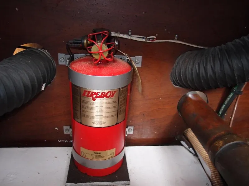 Slide: The Image of Fire extinguisher in the engine room of a 1961 Hatteras Convertible boat. - 24