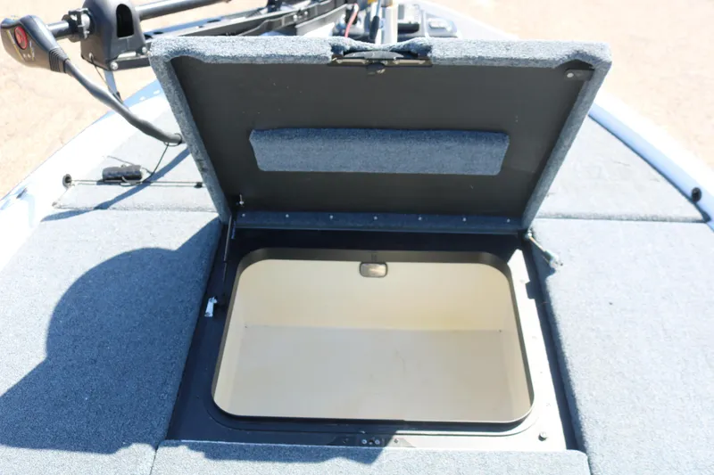 Slide: The Image of Open storage compartment on a 2009 Skeeter 20i boat deck. - 12