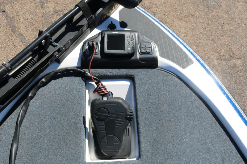 Slide: The Image of 2009 Skeeter 20i boat dashboard with electronic controls and foot pedal. - 13