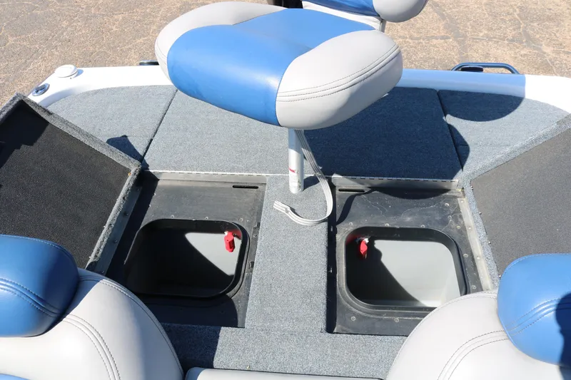 Slide: The Image of 2009 Skeeter 20i boat interior with blue and gray seating and storage compartments. - 17