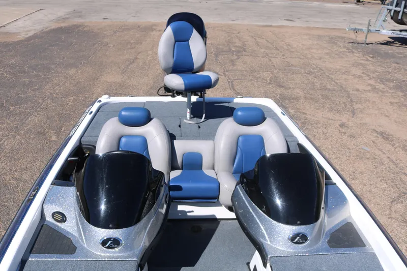 Slide: The Image of 2009 Skeeter 20i boat interior with blue and gray seating and dual consoles. - 7