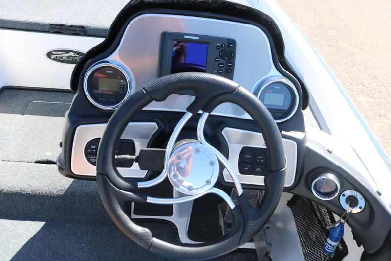 Slide: The Image of 2009 Skeeter 20i boat dashboard with steering wheel and electronic displays. - 8