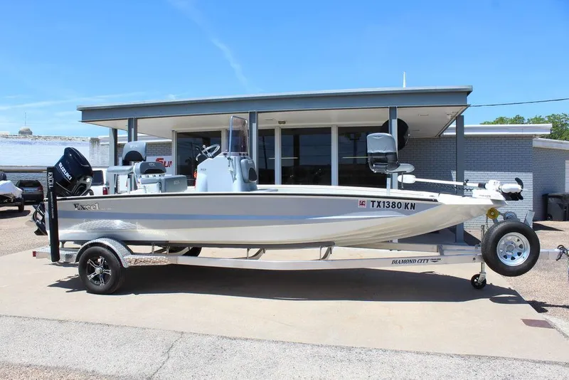 The Image of 2022 Excel Bay Pro 203 boat on a trailer outside a dealership. - 1