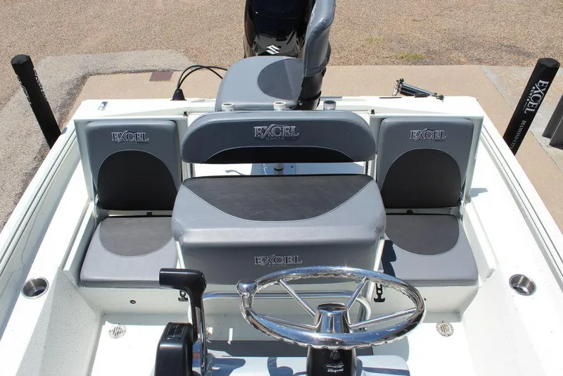 Slide: The Image of 2022 Excel Bay Pro 203 boat interior with steering wheel and seating. - 17