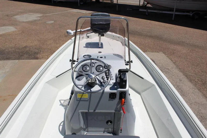 Slide: The Image of 2022 Excel Bay Pro 203 boat interior with steering console and controls. - 9