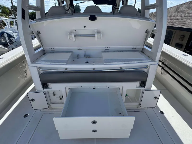 Slide: The Image of 2023 Solace 41 CS boat interior with open storage compartments and seating. - 10