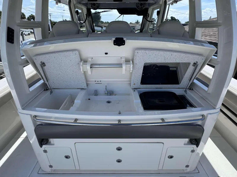 Slide: The Image of 2023 Solace 41 CS boat interior with open storage compartments and sink. - 11