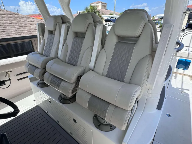 Slide: The Image of Luxury seating on 2023 Solace 41 CS boat, featuring three plush, ergonomic captain's chairs. - 13