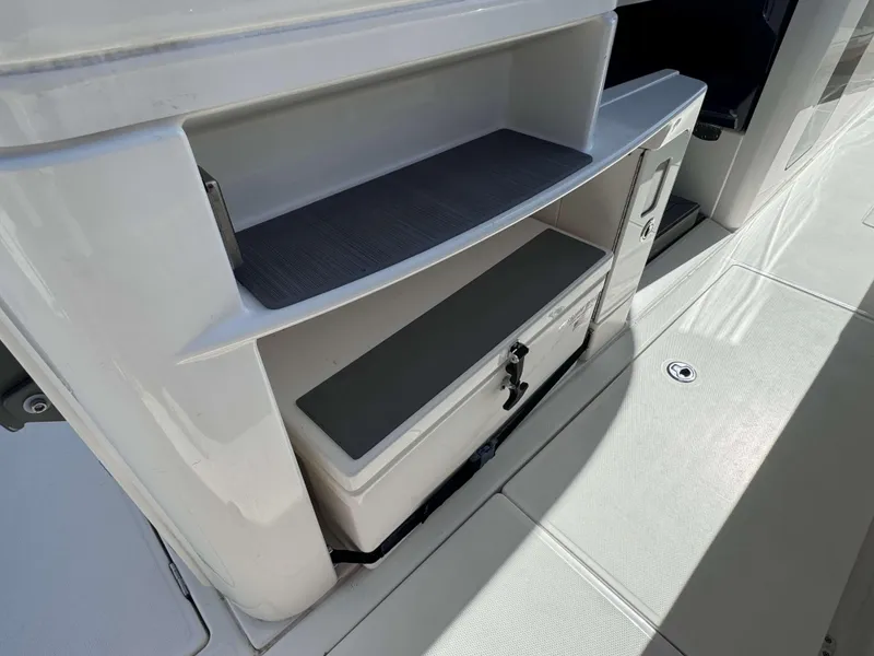 Slide: The Image of 2023 Solace 41 CS boat storage compartment with cooler and shelves. - 18