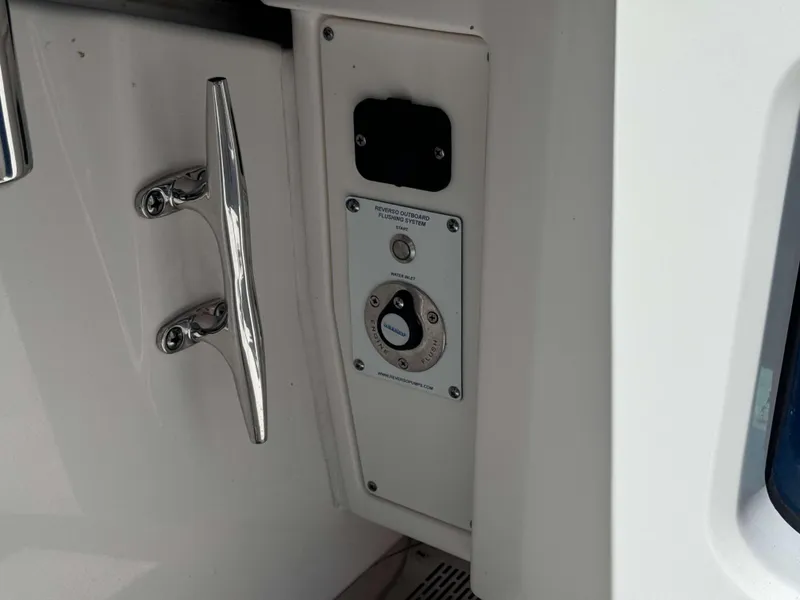 Slide: The Image of Close-up of the 2023 Solace 41 CS boat's outboard flushing system and chrome handle. - 19