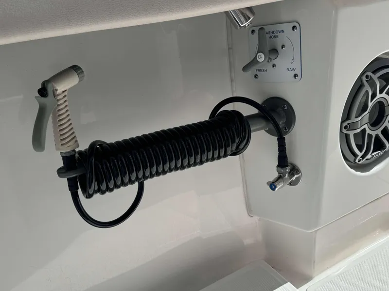 Slide: The Image of Coiled washdown hose and control panel on 2023 Solace 41 CS boat. - 21