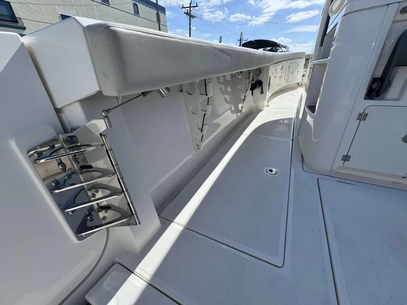 Slide: The Image of 2023 Solace 41 CS boat interior with white cushioned seating and stainless steel fixtures. - 24