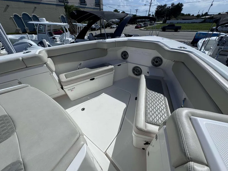 Slide: The Image of 2023 Solace 41 CS boat interior with cushioned seating and built-in speakers. - 28