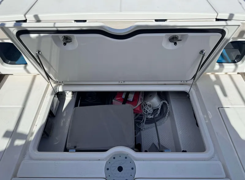 Slide: The Image of Open storage compartment on a 2023 Solace 41 CS boat, showing various boating equipment. - 34
