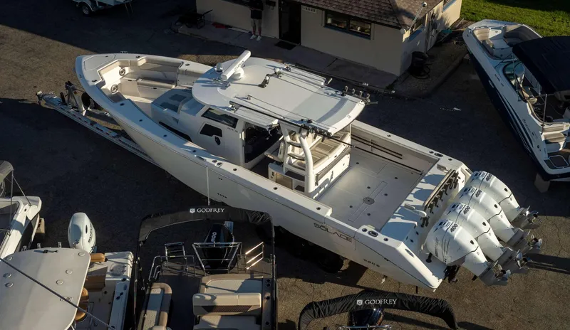 Slide: The Image of 2023 Solace 41 CS boat with triple outboard engines, docked in a marina. - 36
