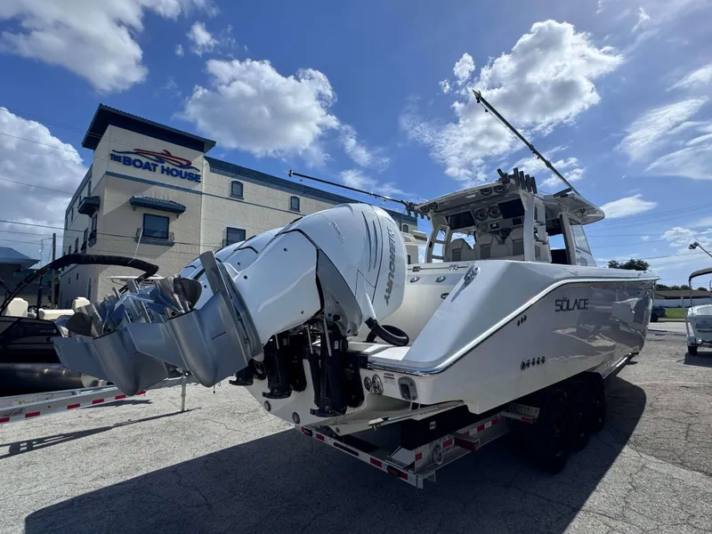 Slide: The Image of 2023 Solace 41 CS boat on trailer at The Boat House under a blue sky. - 5