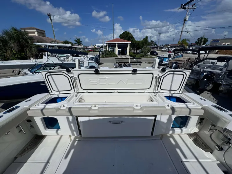 Slide: The Image of 2023 Solace 41 CS boat with open storage compartments and seating area. - 8