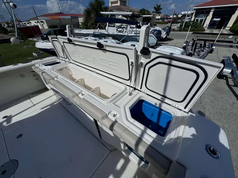 Slide: The Image of 2023 Solace 41 CS boat with open storage compartments and seating area. - 9