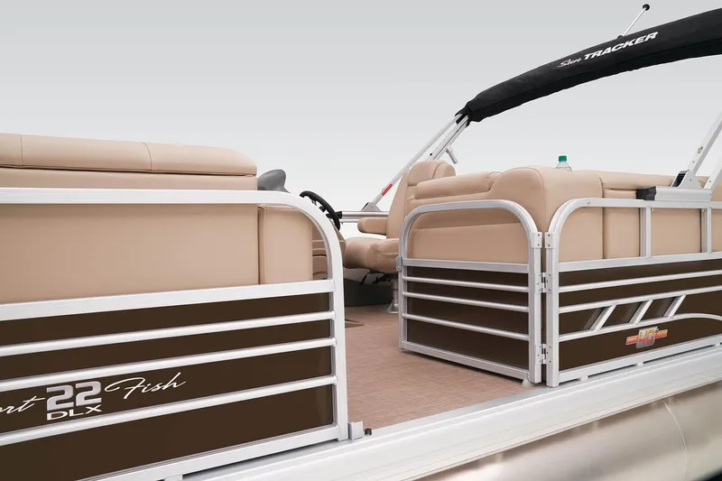 Slide: The Image of 2023 Sun Tracker SportFish 22 DLX pontoon boat interior with beige seating. - 11