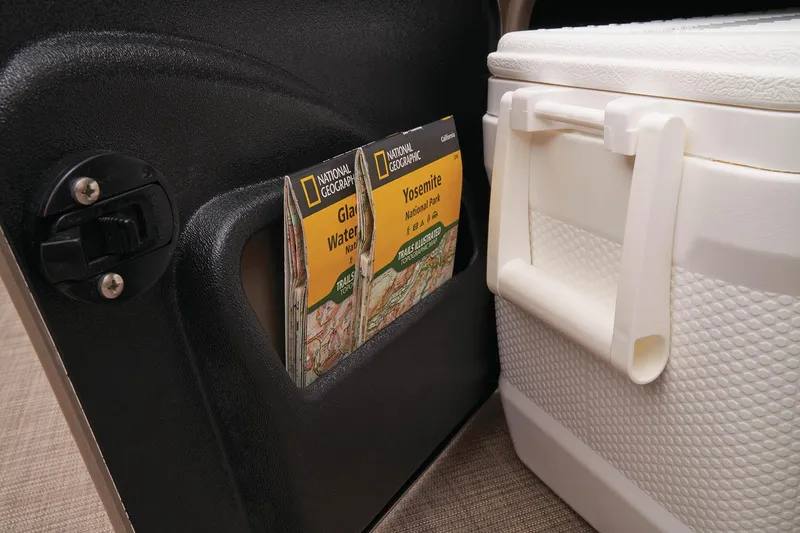 Slide: The Image of Storage compartment with National Geographic maps and cooler on Sun Tracker SportFish 22 DLX, 2023 model. - 23