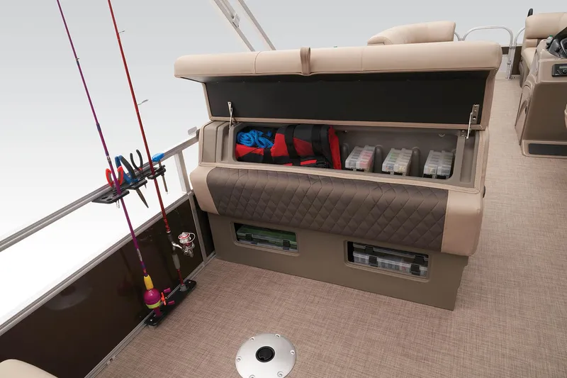 Slide: The Image of 2023 Sun Tracker SportFish 22 DLX storage compartment with fishing gear and rods. - 33
