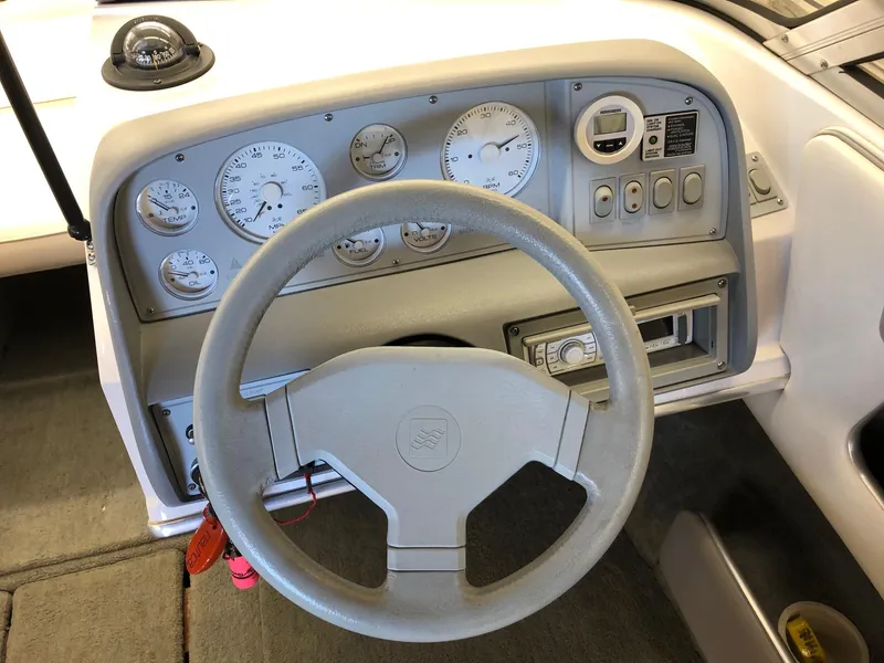 Slide: The Image of 1992 Four Winns 220 Horizon Open Bow boat dashboard with steering wheel and gauges. - 11