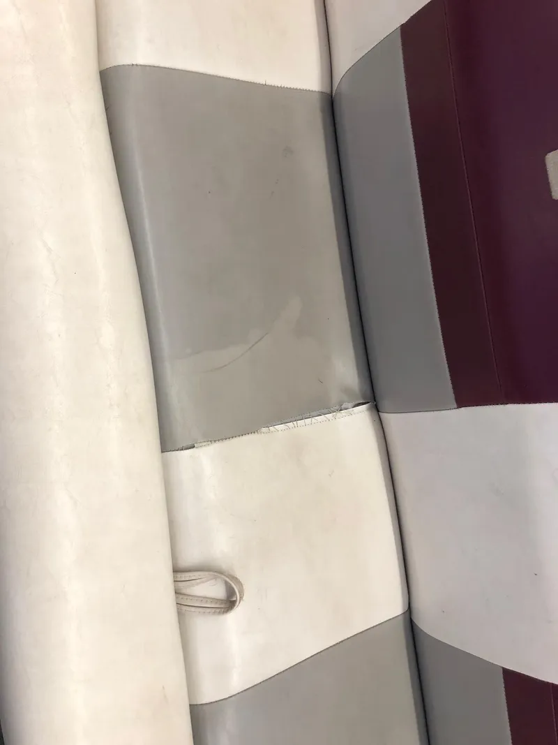 Slide: The Image of 1992 Four Winns 220 Horizon Open Bow boat seat with white, gray, and maroon upholstery. - 19